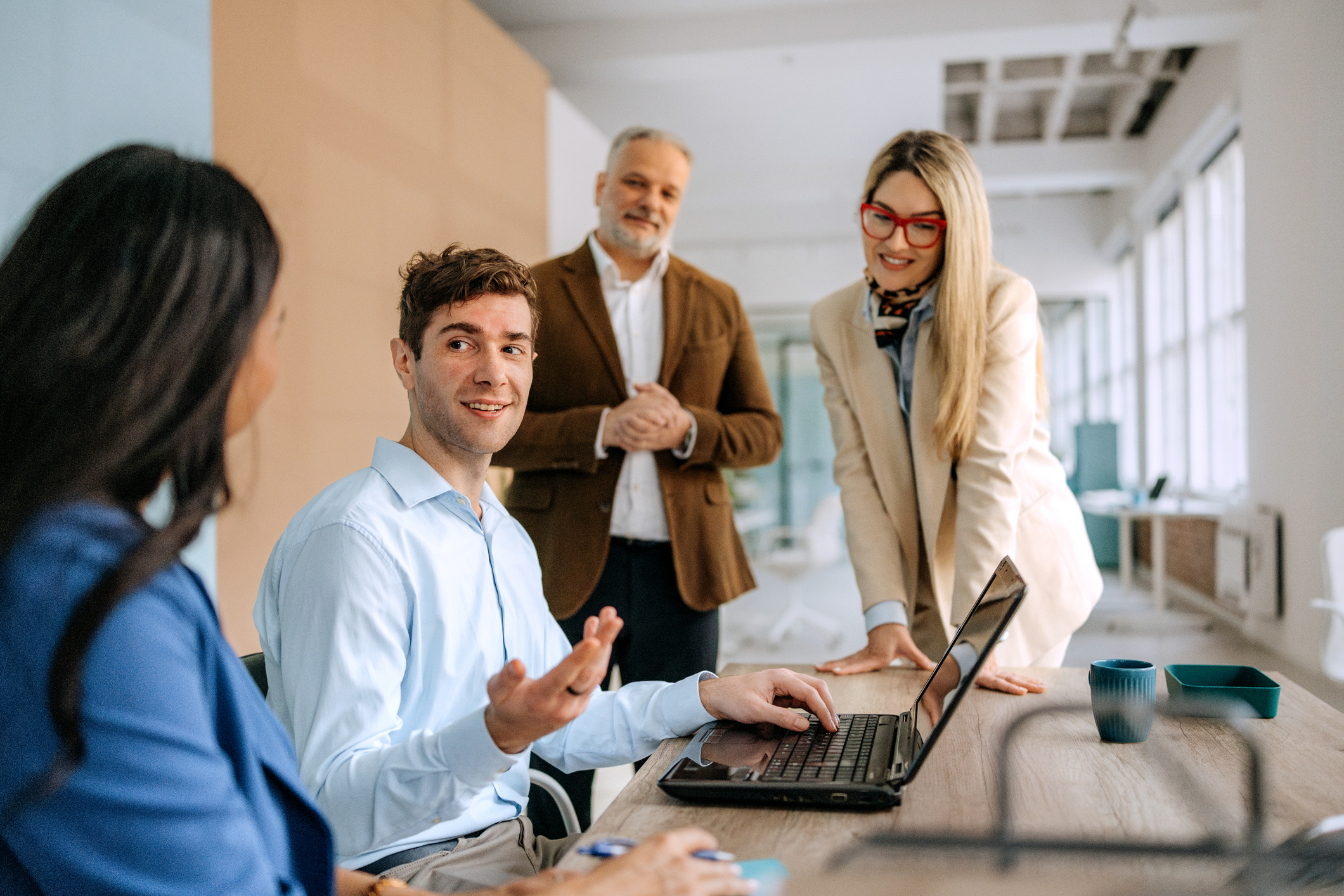 Diverse team members engage in a productive discussion while collaborating in a modern office setting