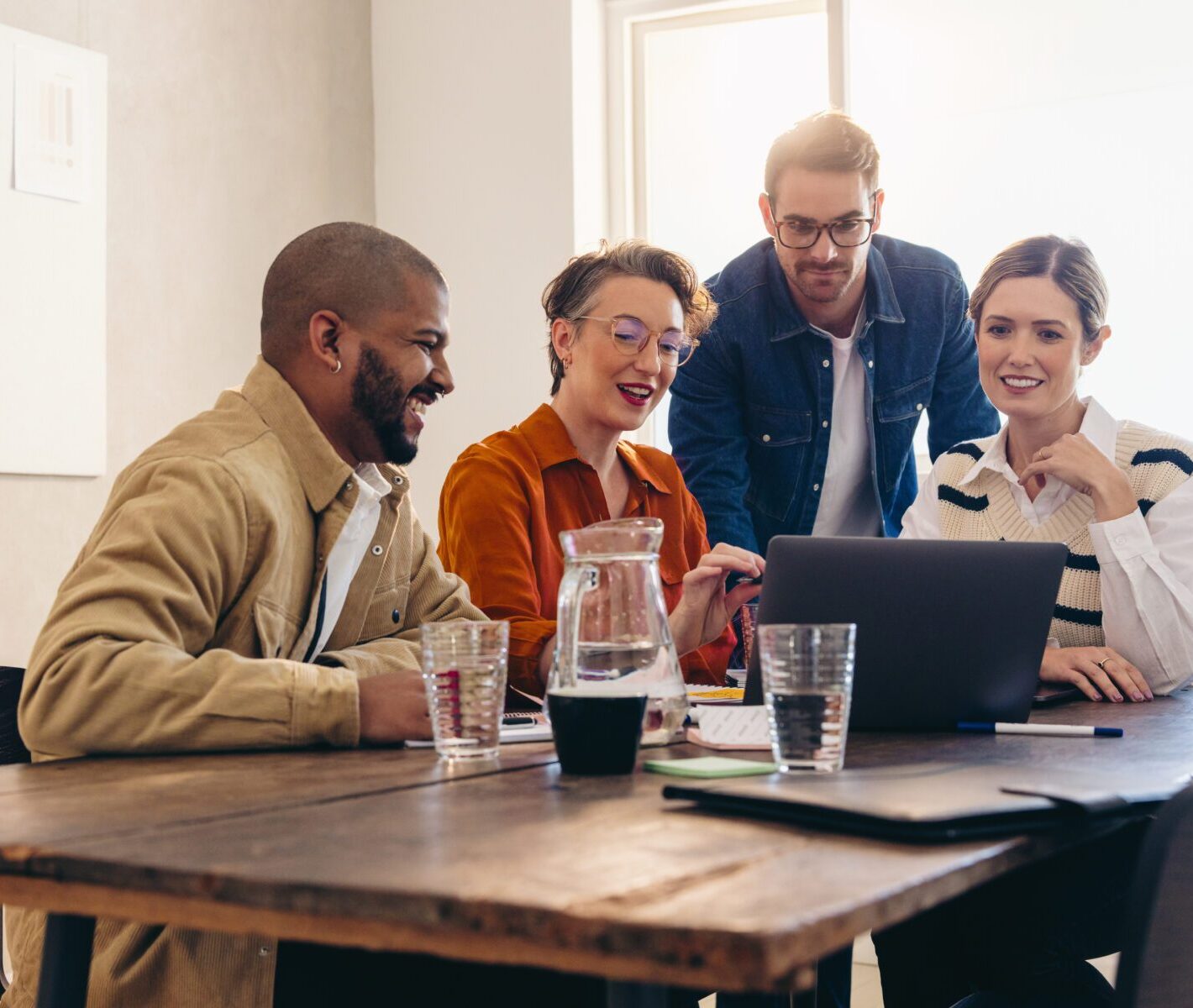 Cheerful business colleagues watching a presentation on a laptop