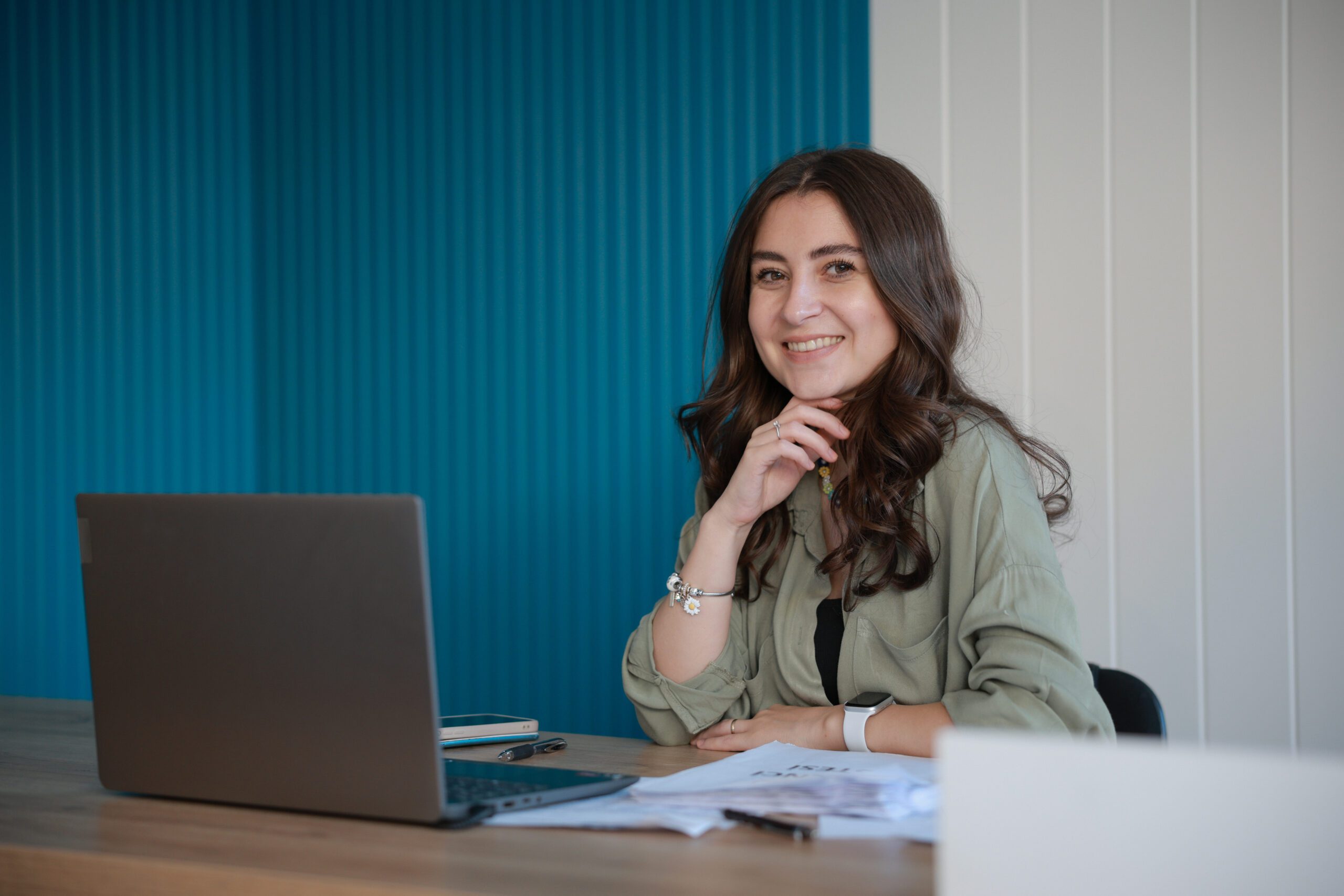 Young confident smiling businesswoman, successful entrepreneur working in modern office
